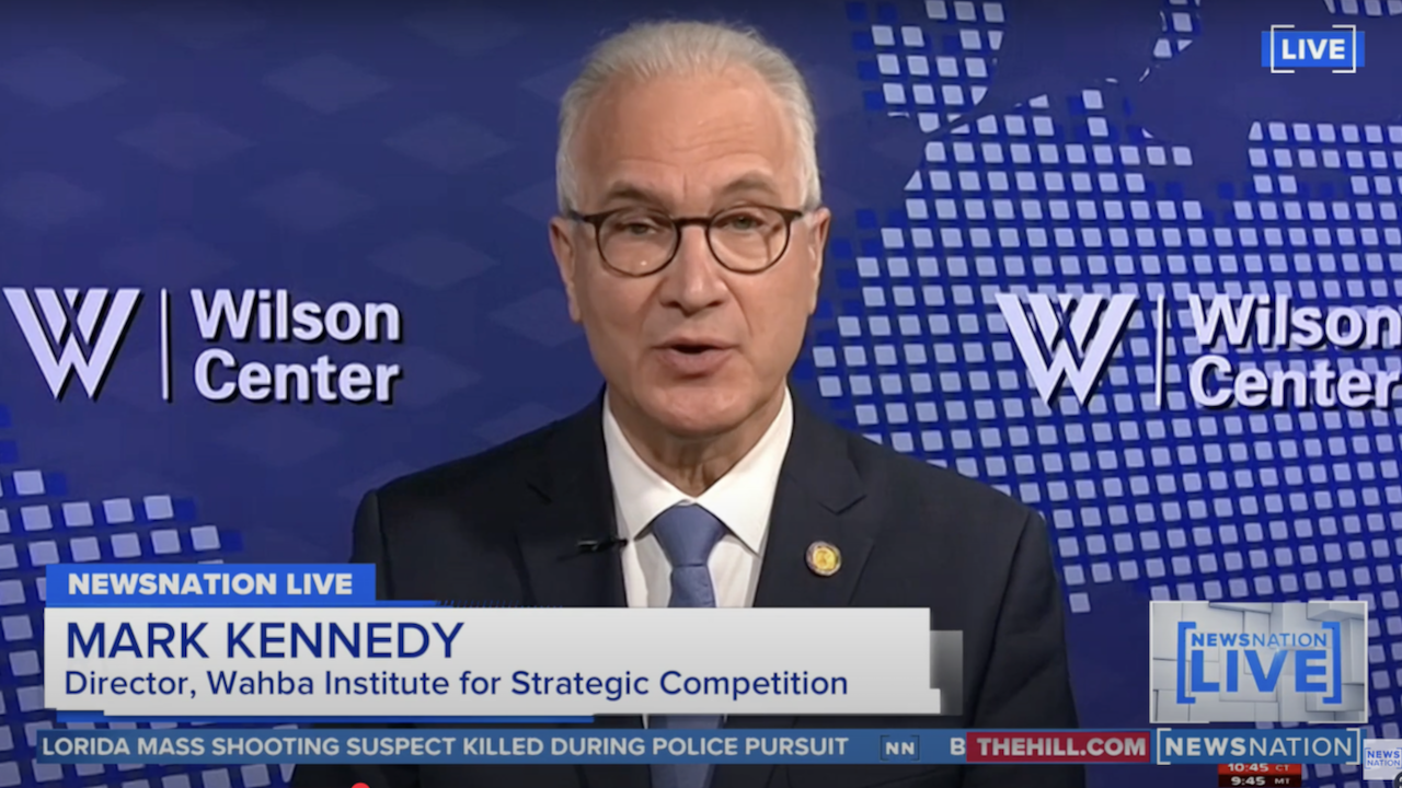 A man in a suit and glasses speaks during a live NewsNation interview. The screen identifies him as Mark Kennedy, Director of the Wahba Institute for Strategic Competition at the Wilson Center. A world map graphic is in the background.